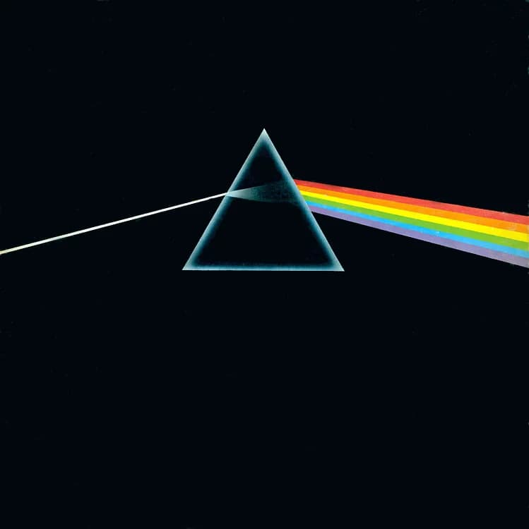 A prism refracting white light into a rainbow on a black background